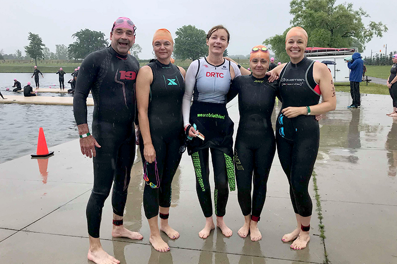 five members in their wetsuits